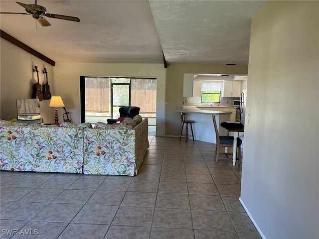 tiled living room with ceiling fan