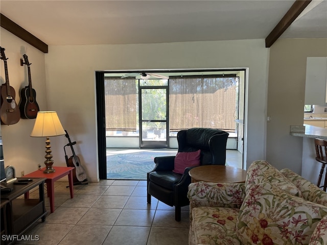 living room featuring beamed ceiling and light tile patterned flooring