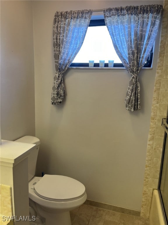 bathroom with walk in shower and toilet