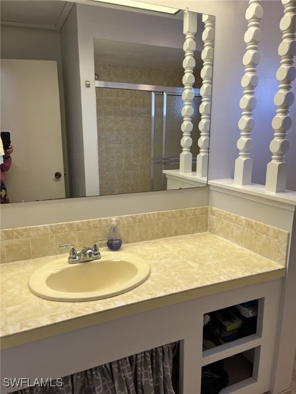 bathroom featuring vanity and an enclosed shower