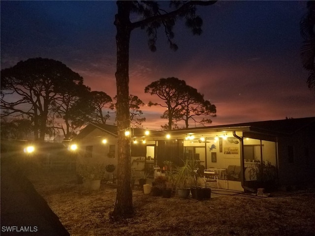 back house at dusk with a patio