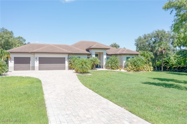 view of front of house featuring a garage and a front lawn