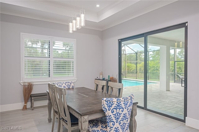 dining room with a chandelier, light hardwood / wood-style flooring, plenty of natural light, and crown molding