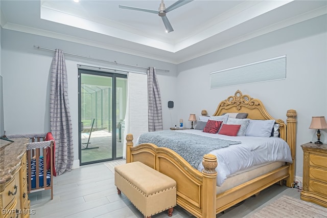 bedroom featuring light wood-type flooring, ornamental molding, access to outside, a raised ceiling, and ceiling fan