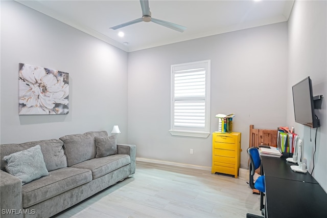 living room featuring ceiling fan, light hardwood / wood-style flooring, and ornamental molding