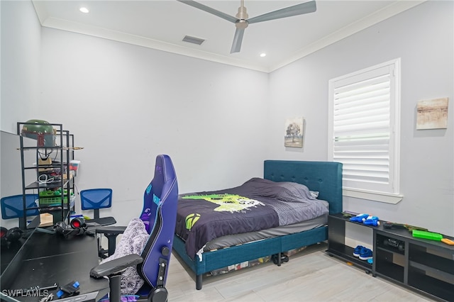 bedroom with hardwood / wood-style flooring, ceiling fan, and ornamental molding