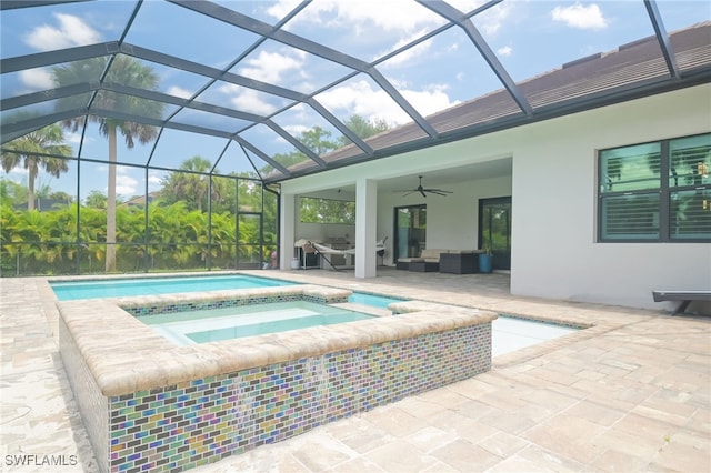 view of pool with glass enclosure, an outdoor hangout area, ceiling fan, an in ground hot tub, and a patio area