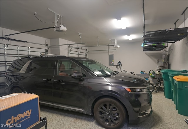 garage featuring electric panel and a garage door opener