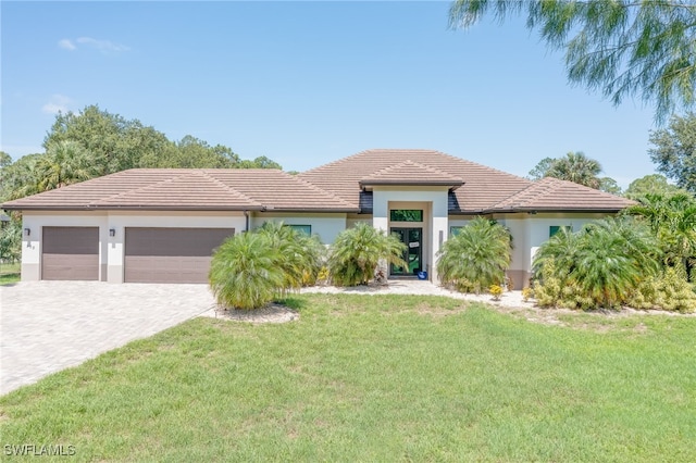 view of front of house with a front lawn and a garage