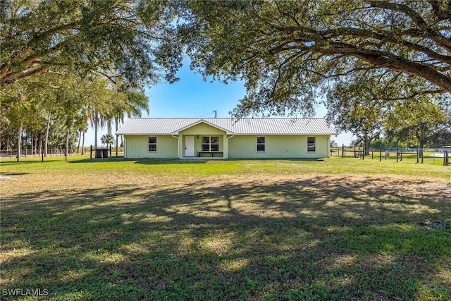 back of property featuring a yard