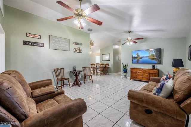 living room featuring ceiling fan, light tile patterned flooring, and vaulted ceiling