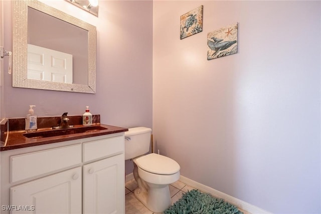 bathroom with tile patterned floors, vanity, and toilet