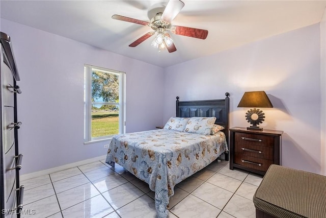 tiled bedroom featuring ceiling fan