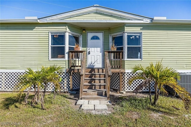 doorway to property featuring central AC unit