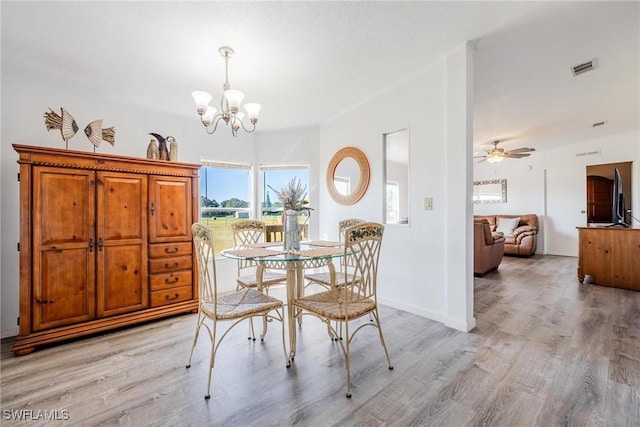 dining room with light hardwood / wood-style floors and ceiling fan with notable chandelier