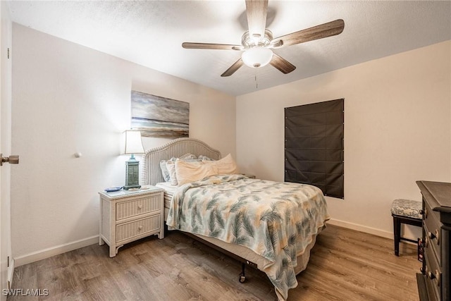 bedroom with ceiling fan and light hardwood / wood-style flooring