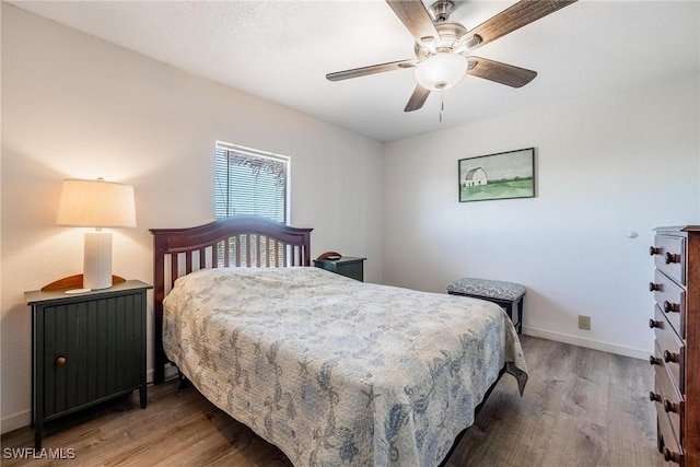 bedroom featuring hardwood / wood-style flooring and ceiling fan