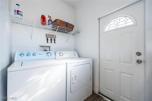 laundry room with hardwood / wood-style flooring and washer and dryer