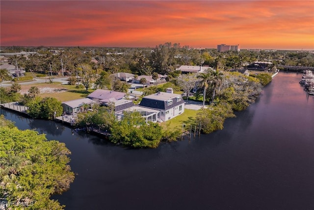 aerial view at dusk with a water view