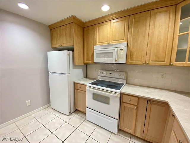 kitchen with white appliances, light tile patterned floors, and tasteful backsplash