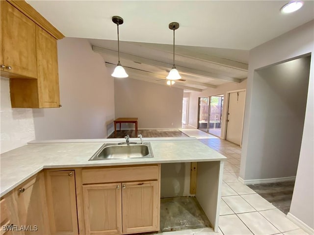 kitchen with pendant lighting, lofted ceiling with beams, sink, light hardwood / wood-style flooring, and kitchen peninsula