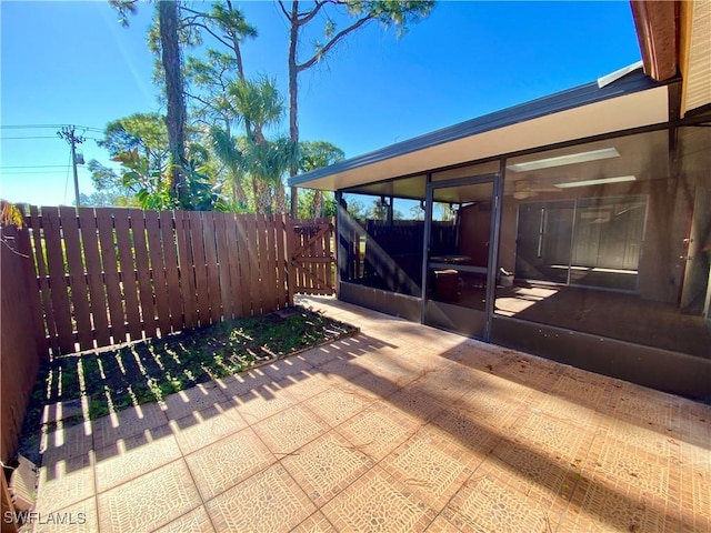 view of patio / terrace featuring a sunroom