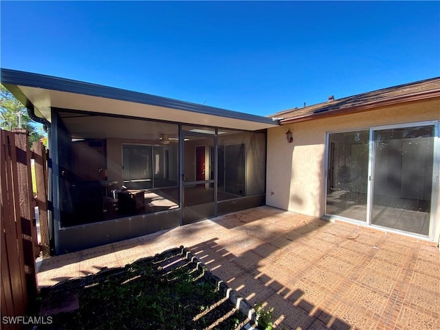 back of house with a sunroom and a patio