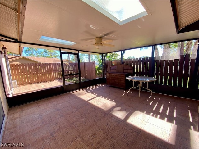 unfurnished sunroom with ceiling fan and a healthy amount of sunlight