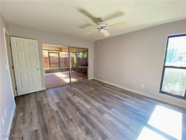 empty room with hardwood / wood-style floors, a textured ceiling, and ceiling fan