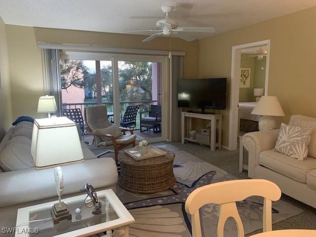 carpeted living room with ceiling fan