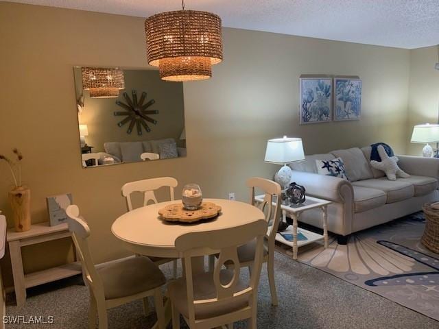 dining space featuring carpet flooring and a textured ceiling