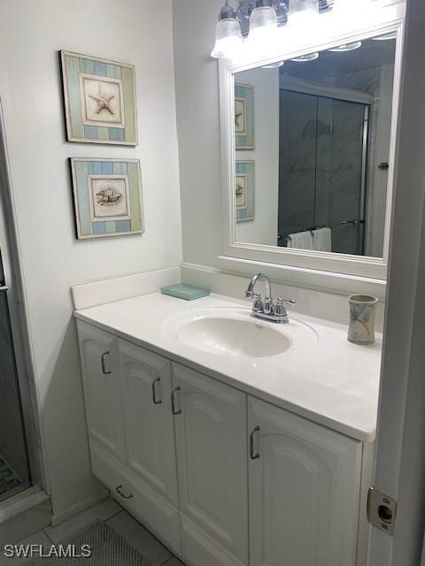 bathroom featuring tile patterned flooring, vanity, and a shower with door