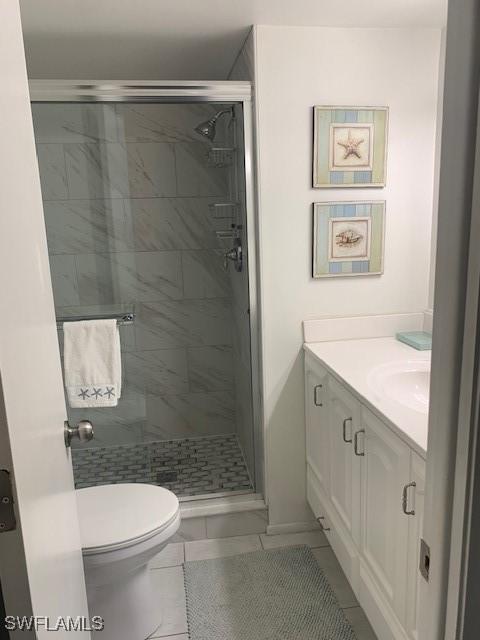 170 Turtle Lake Ct Unit 304, Naples, FL 34105 - bathroom with vanity, a shower stall, and tile patterned flooring