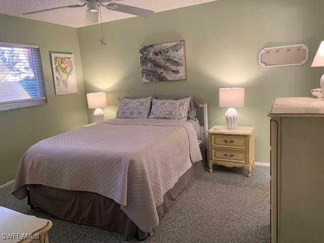 carpeted bedroom featuring ceiling fan