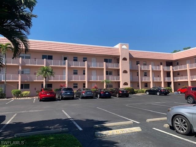 170 Turtle Lake Ct Unit 304, Naples, FL 34105 - view of building exterior with uncovered parking