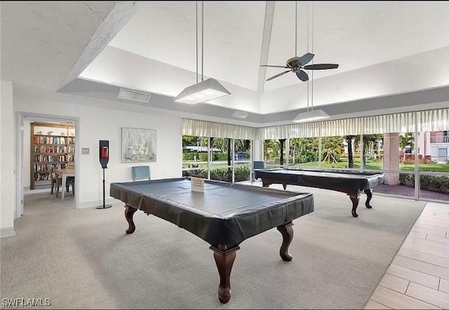 playroom featuring a towering ceiling, a tray ceiling, ceiling fan, and pool table