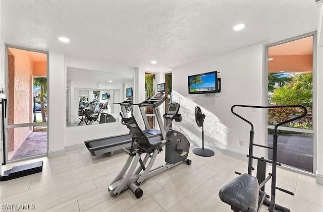 workout room featuring a healthy amount of sunlight and a textured ceiling