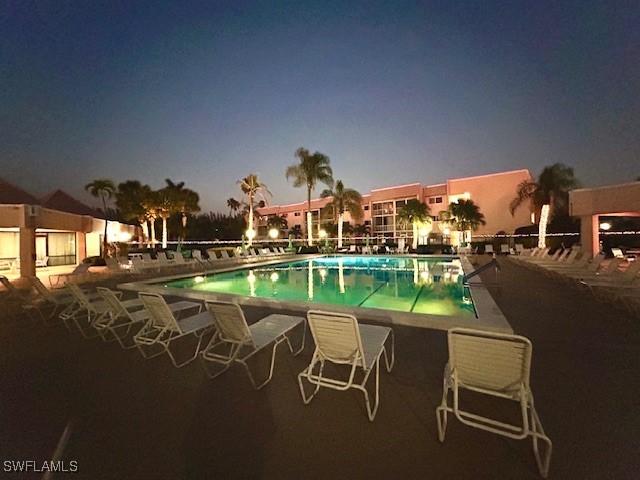 view of pool at dusk