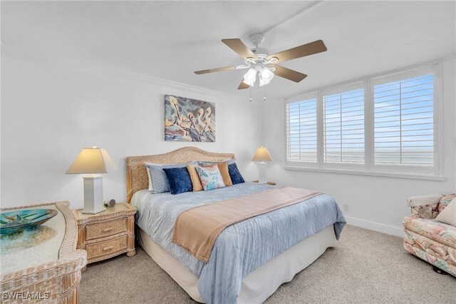 carpeted bedroom featuring baseboards and a ceiling fan