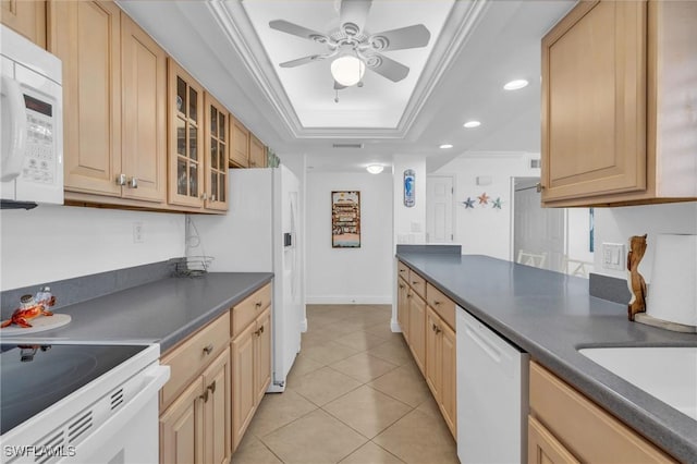 kitchen featuring white appliances, a raised ceiling, dark countertops, glass insert cabinets, and crown molding