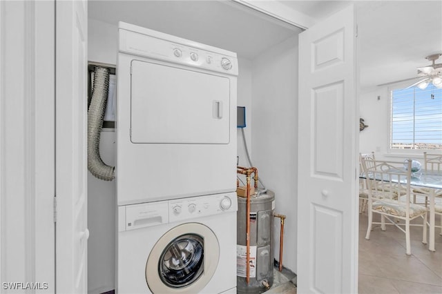 washroom featuring laundry area, stacked washer / dryer, ceiling fan, water heater, and light tile patterned flooring