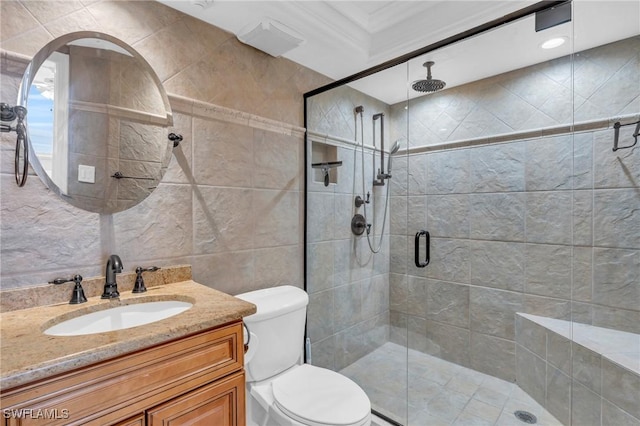 full bath featuring a stall shower, tile walls, toilet, and vanity