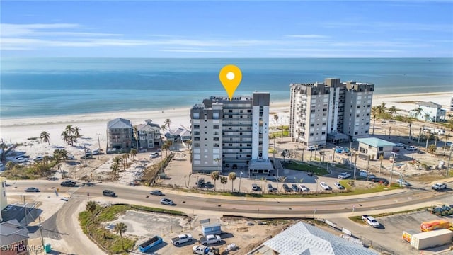 drone / aerial view with a view of the beach, a water view, and a view of city