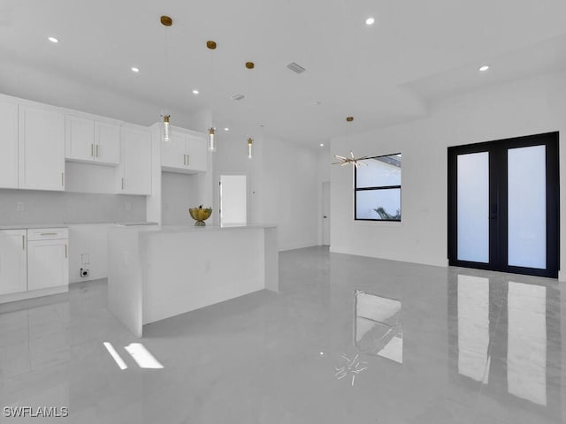 kitchen featuring white cabinetry, a kitchen island, hanging light fixtures, and ceiling fan