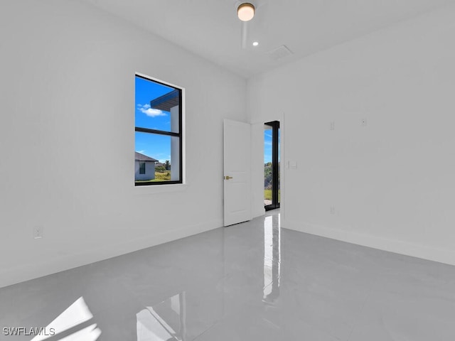 empty room with plenty of natural light and concrete flooring