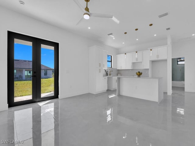 unfurnished living room featuring french doors and ceiling fan