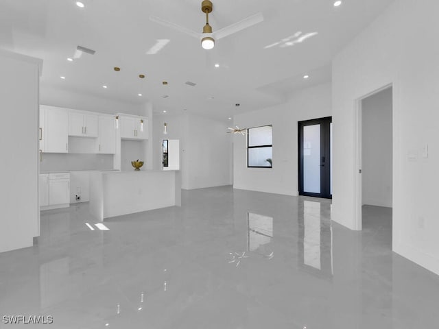 unfurnished living room featuring ceiling fan