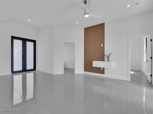 spare room featuring ceiling fan and french doors