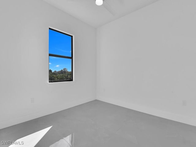 unfurnished room with concrete floors