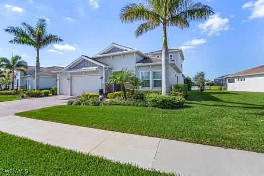 view of front of home with a garage and a front yard